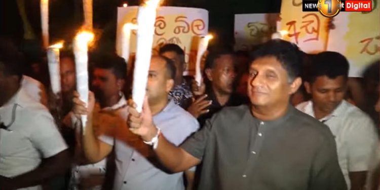 Sajith takes to the streets late at night with torches to protest the high cost of living! VIDEO