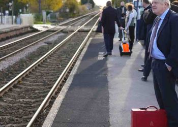 Former British PM travels by train carries his own luggage and a bacpack !