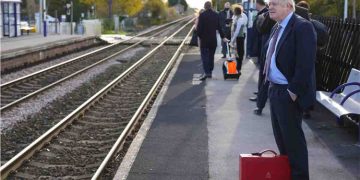 Former British PM travels by train carries his own luggage and a bacpack !